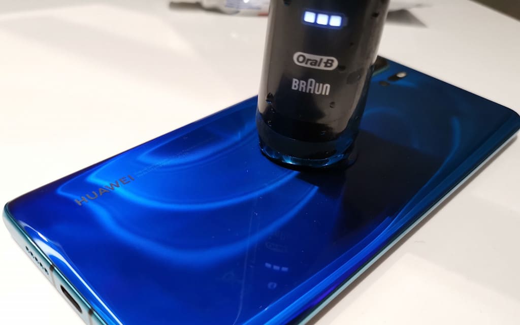 Huawei's P30 Pro recharging an Oral-B electric toothbrush