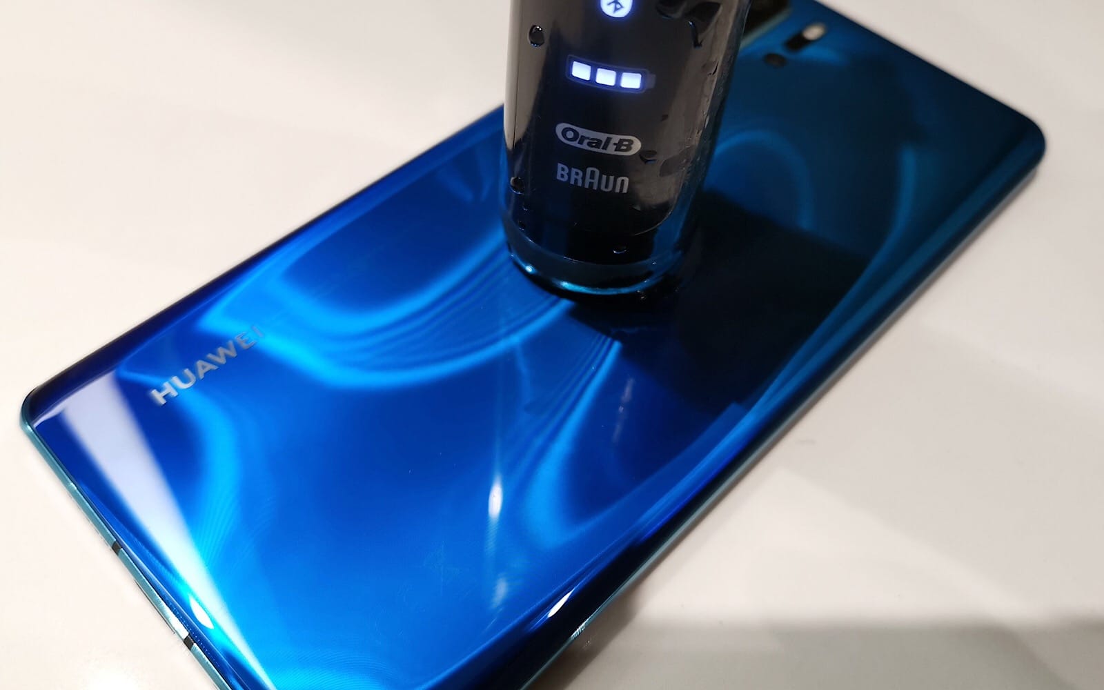 Huawei's P30 Pro recharging an Oral-B electric toothbrush