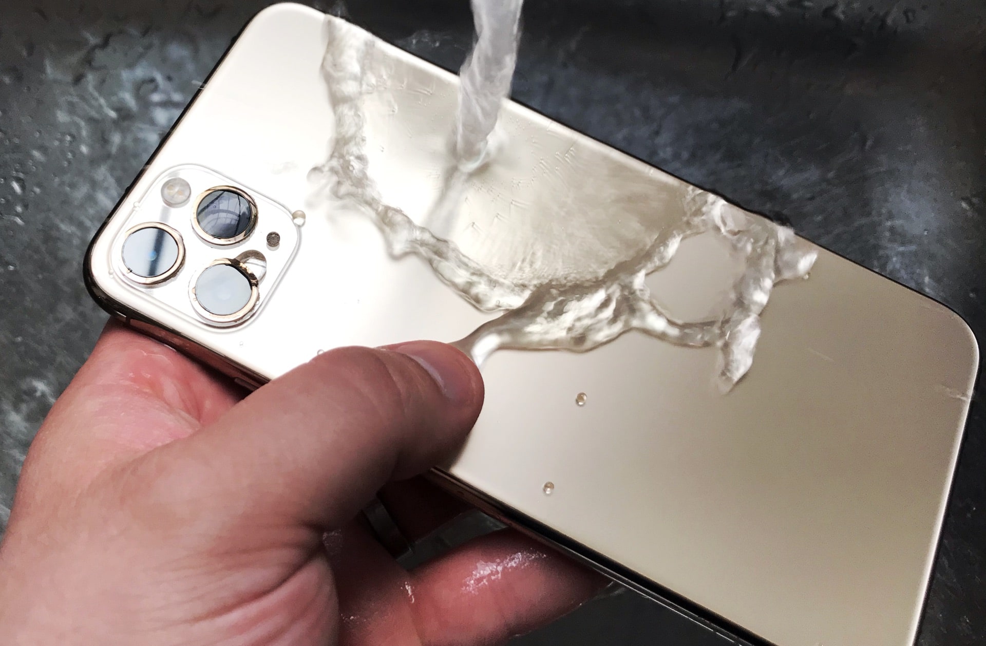 Washing an iPhone 11 Pro Max under a tap