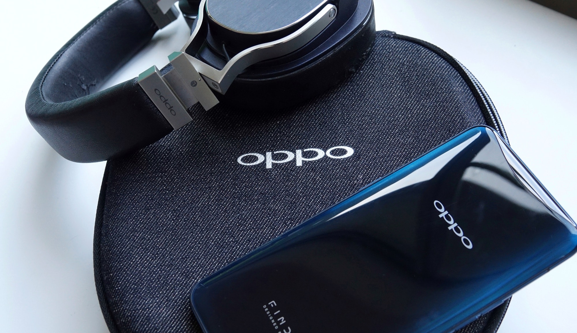 Old Oppo Digital headphones next to the Oppo Find X
