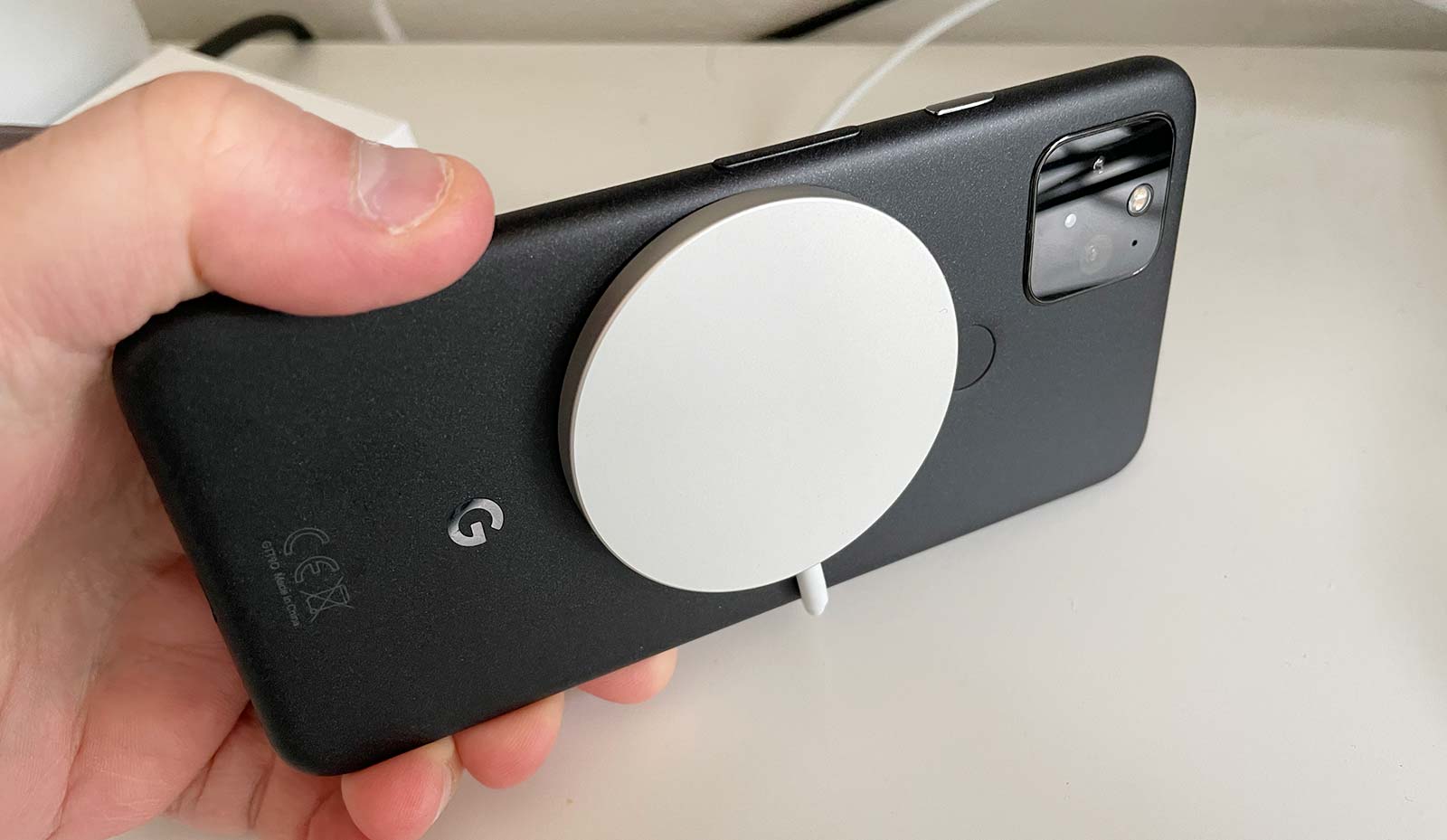 A Google Pixel 5 on a MagSafe charger