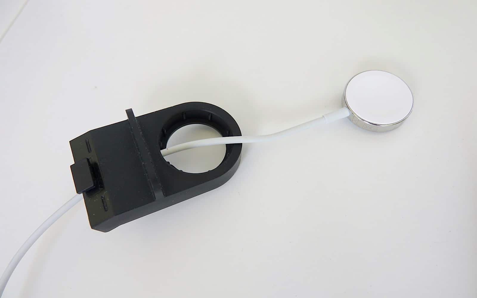The Apple Watch stand requires your own Apple Watch charger to be threaded through.