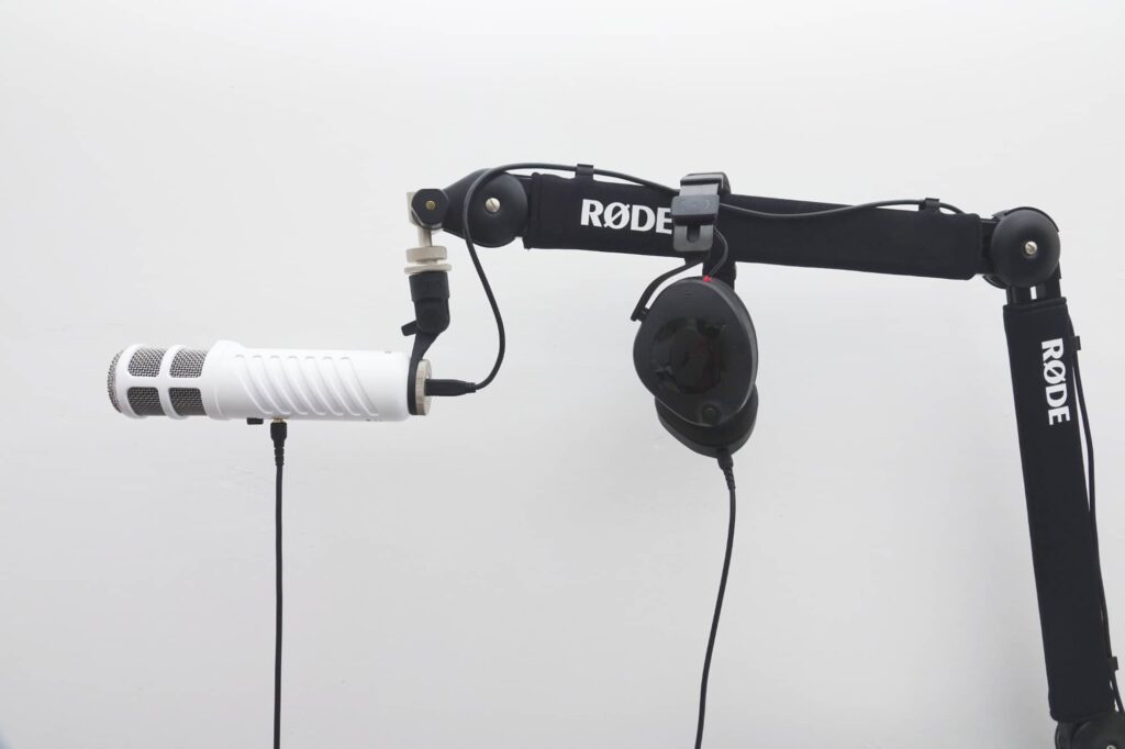 Rode NTH-100 hanging on the Rode PSA1+ mic stand connected to a Podcaster mic