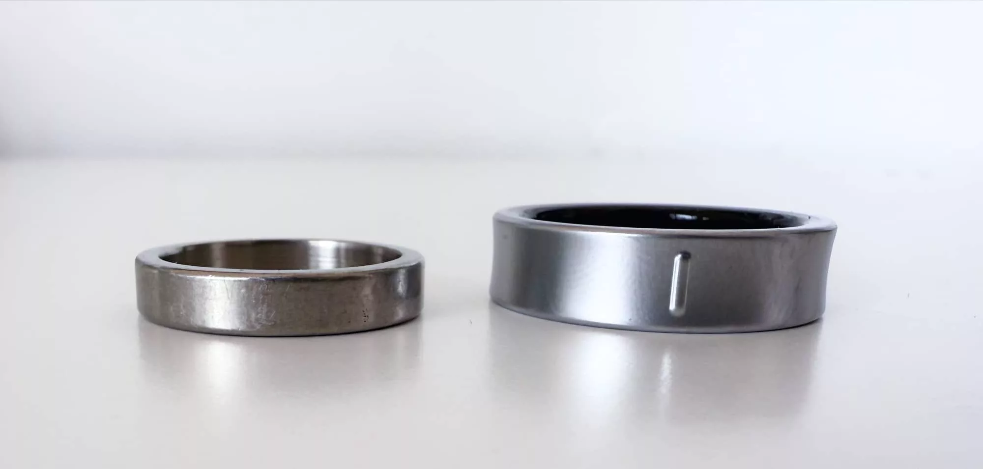 The Galaxy Ring (right) next to a titanium wedding band.